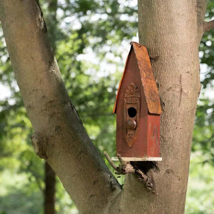Rustic Brown Wooden Birdhouse with Iron Roof mounted on a tree.