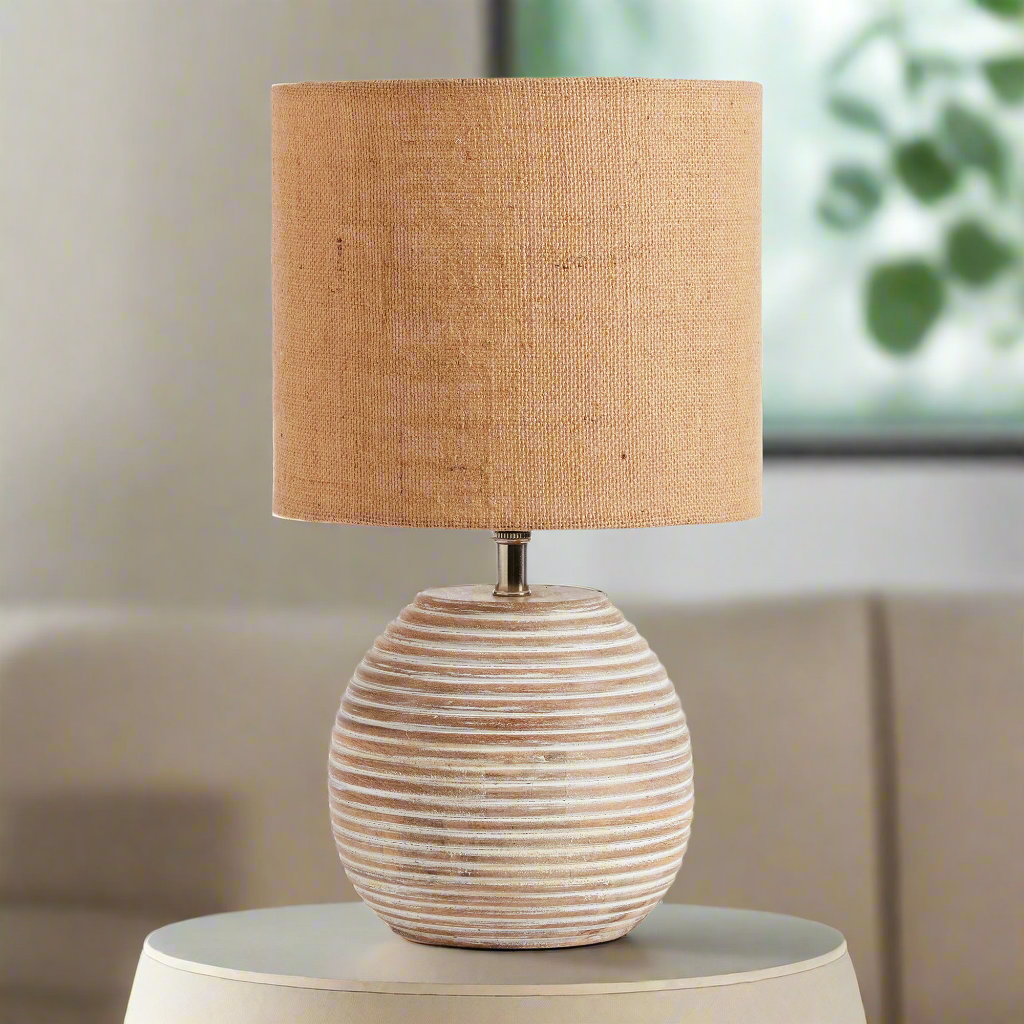 Rustic mango wood table lamp with ribbed base and warm linen shade for elegant home decor.