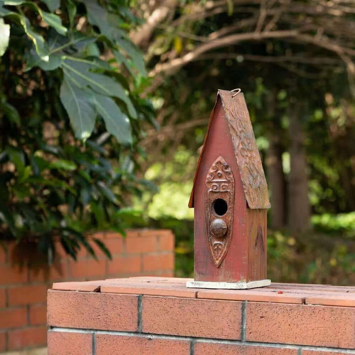 Rustic Brown Wooden Birdhouse with Iron Roof set in a garden setting