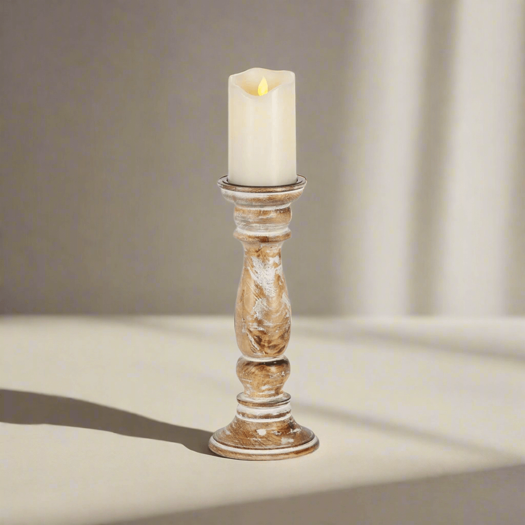 Rustic farmhouse whitewashed wooden candle holder with lit candle on a light background.