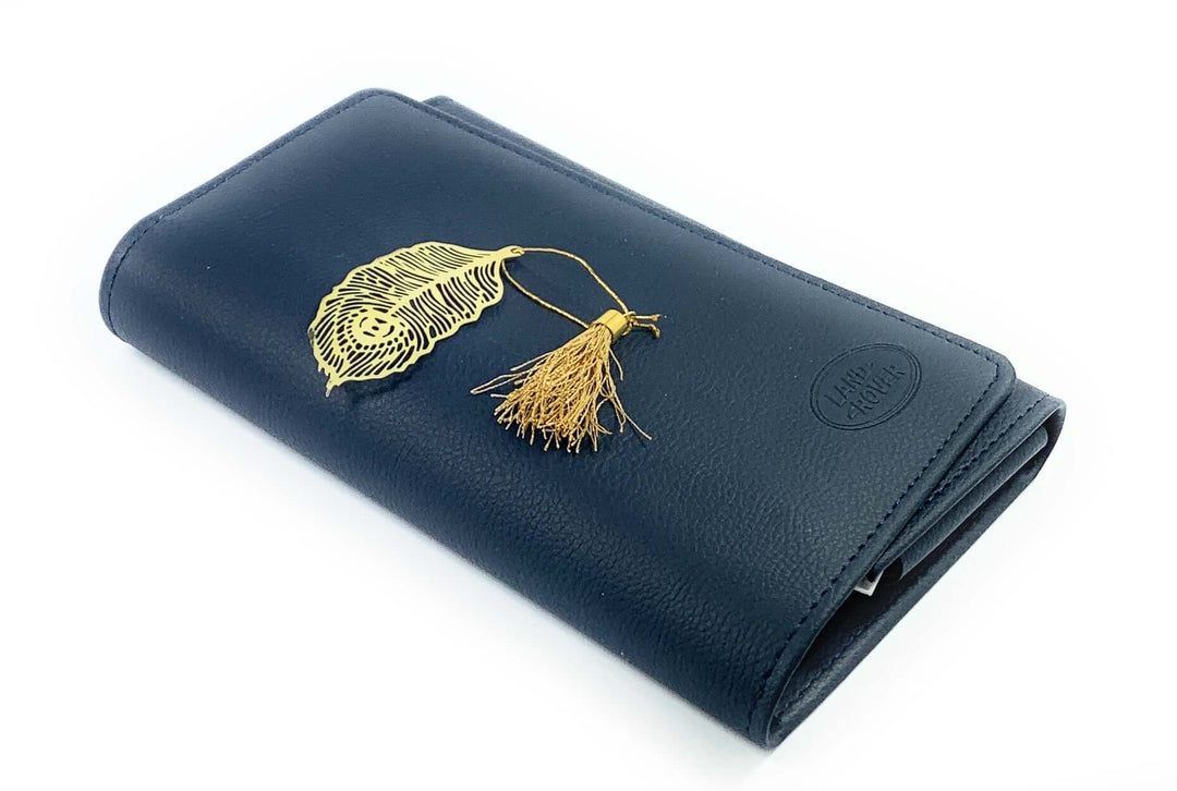 Vintage Brass Feather Bookmark with Tassel (Set of 6) on a leather notebook, featuring a detailed feather and golden tassel.