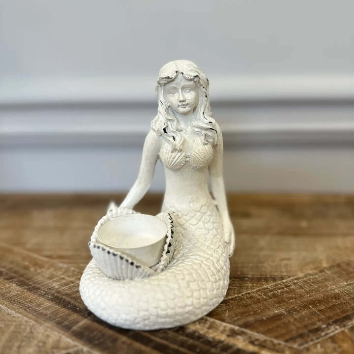 Vintage Coastal White Mermaid Candle Holder with seashell for tealight on wooden surface.