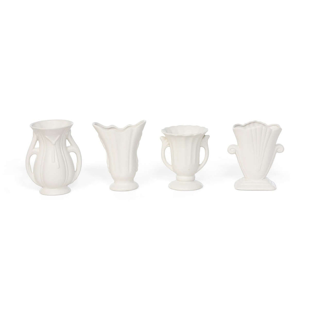 Set of 4 vintage-inspired white ceramic vases with elegant curves and matte finish, perfect for home decor elegance.
