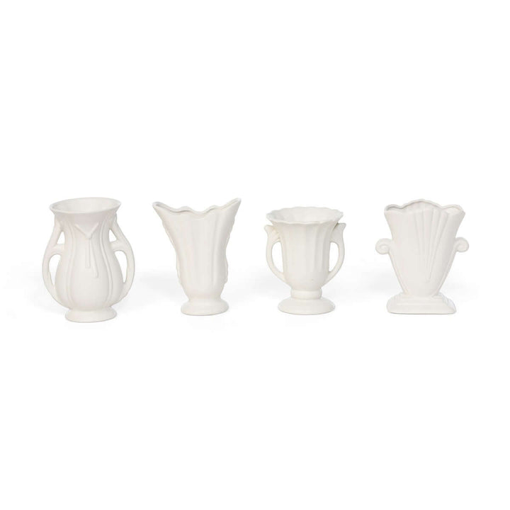 Set of 4 vintage-inspired white ceramic vases with elegant curves and matte finish, perfect for home decor elegance.