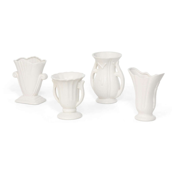 Vintage-inspired white ceramic vases set of 4 with matte glaze and elegant curves, including fluted necks and scalloped rims.