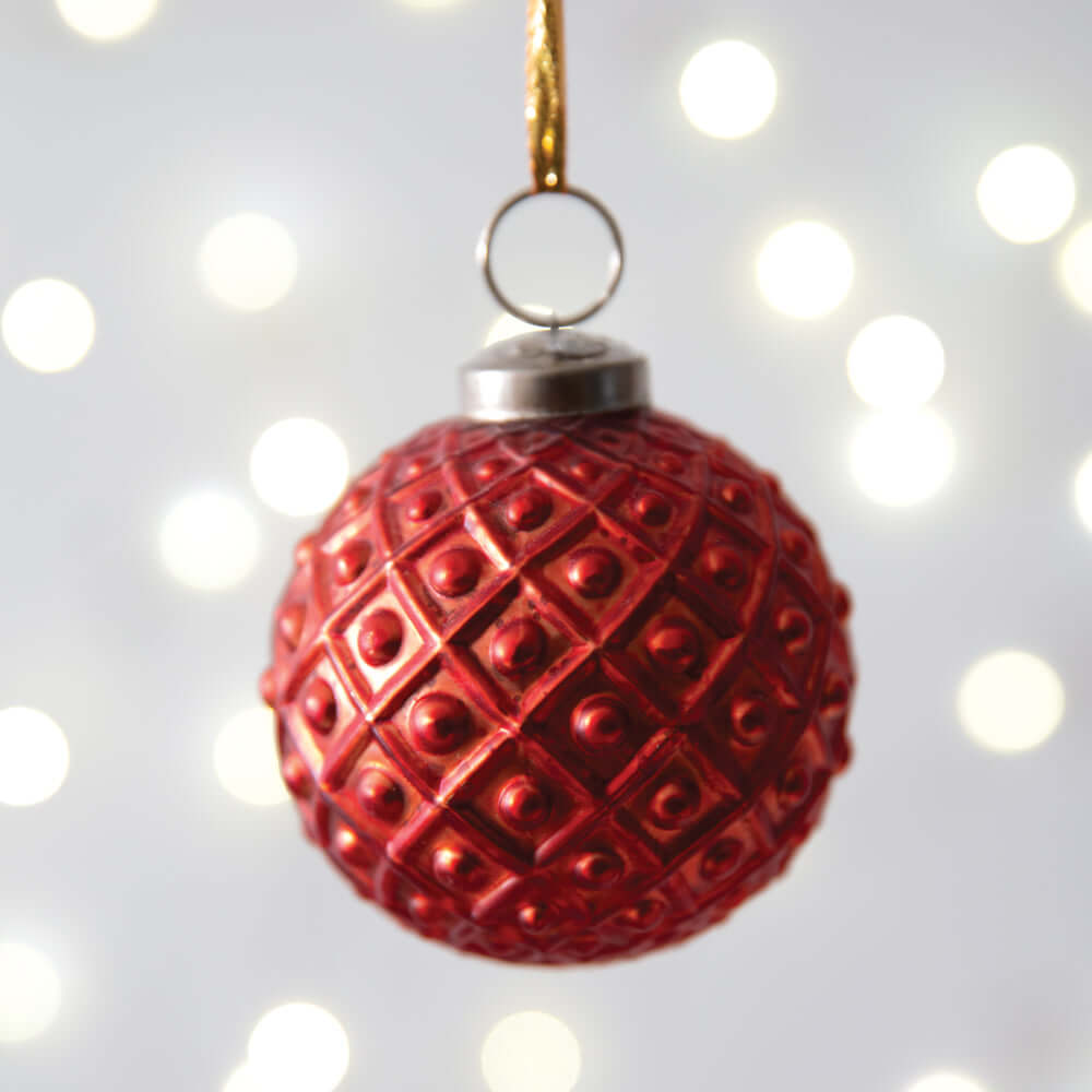 Vintage Red Mercury Glass Christmas Ornament (Set of 4) with diamond pattern, highlighted by holiday lights, ready to hang.