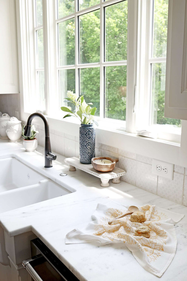 Vintage Sunflower Tea Towel displayed on a bright kitchen countertop, emphasizing its elegant sunflower watercolor design.