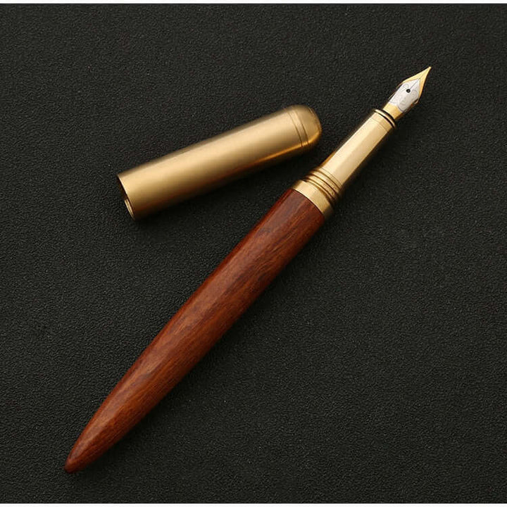 Vintage Wood and Brass Fountain Pen | The Hemmingway displayed on a dark background