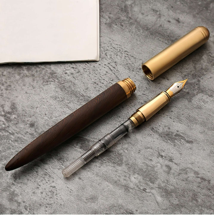 Vintage Wood and Brass Fountain Pen | The Hemmingway displayed on a stone surface