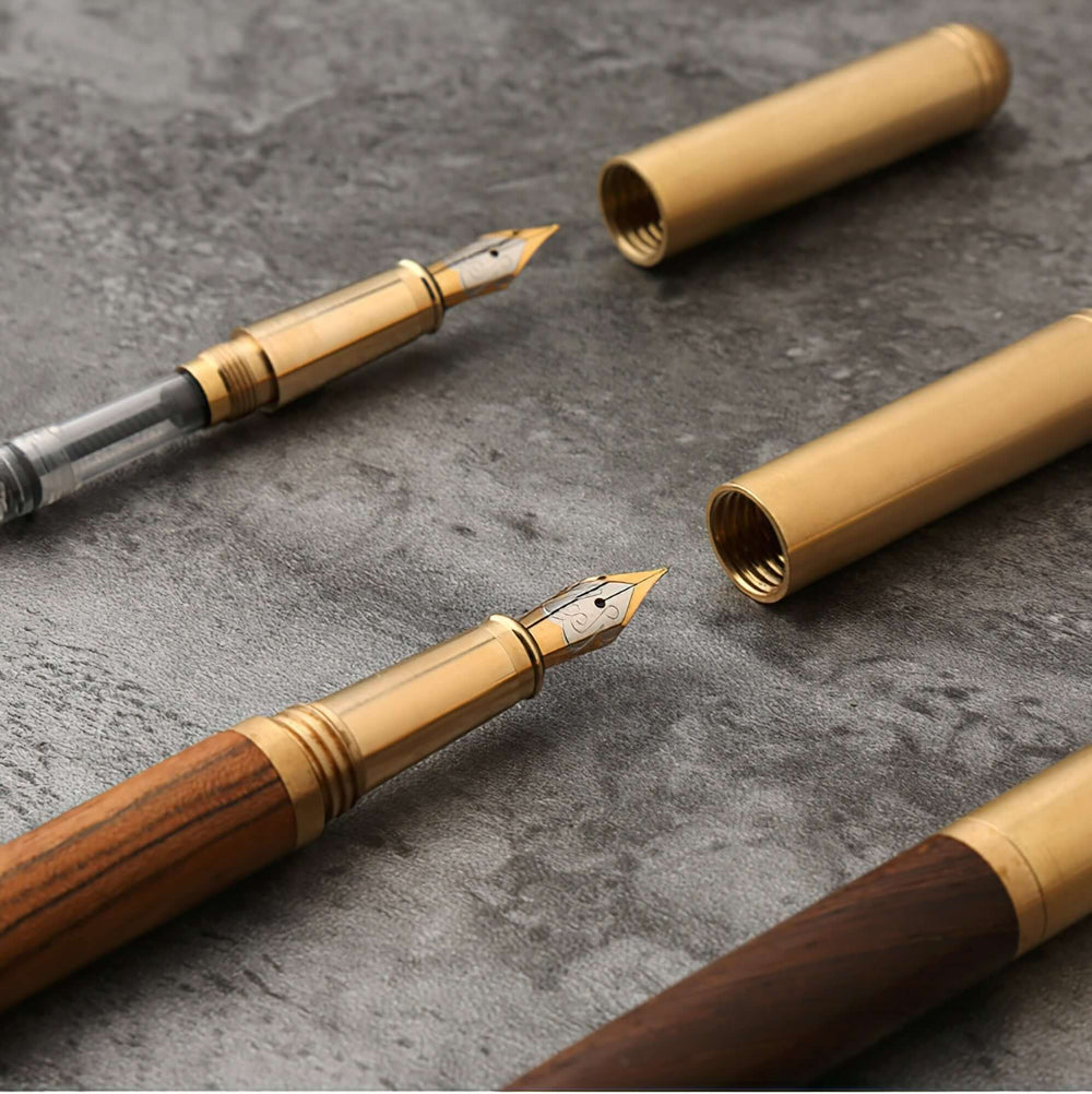 Vintage Wood and Brass Fountain Pen | The Hemmingway on display with open caps on a textured surface.