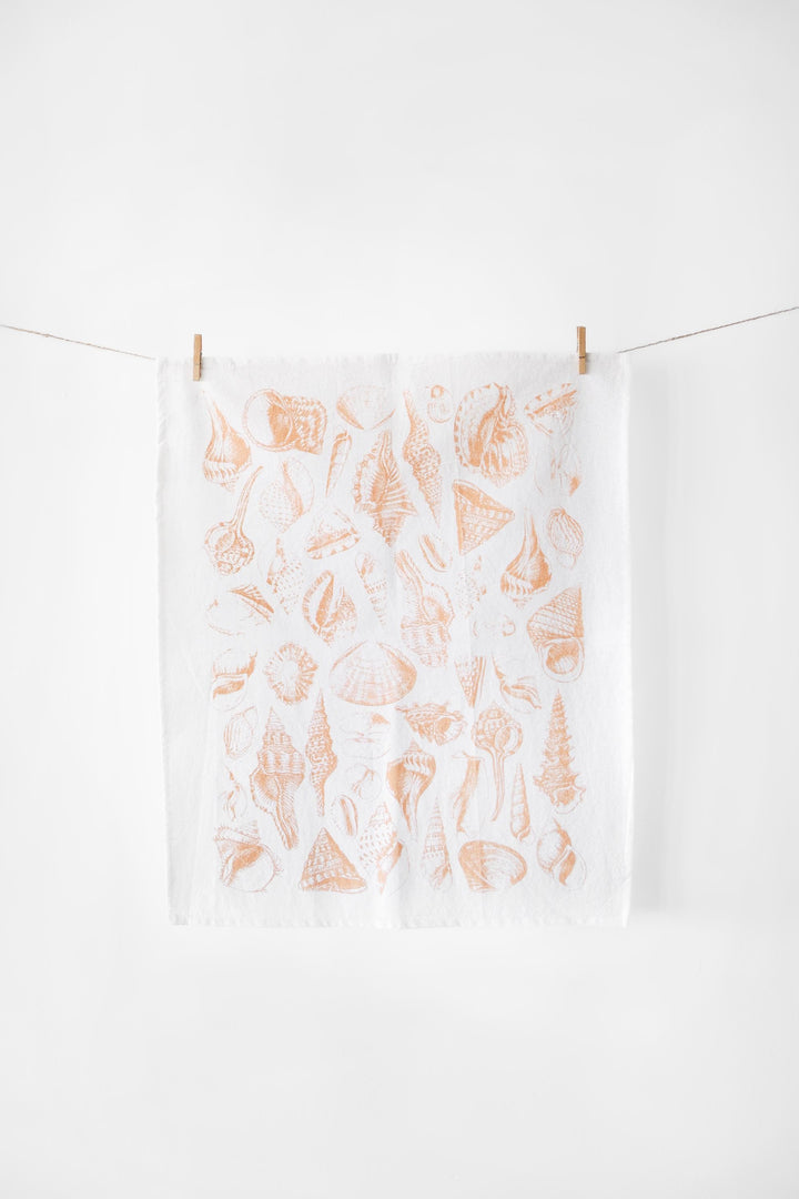 Vintage Coastal Seashell Tea Towel with watercolor-style seashells on white fabric, offering seaside serenity for your kitchen decor.