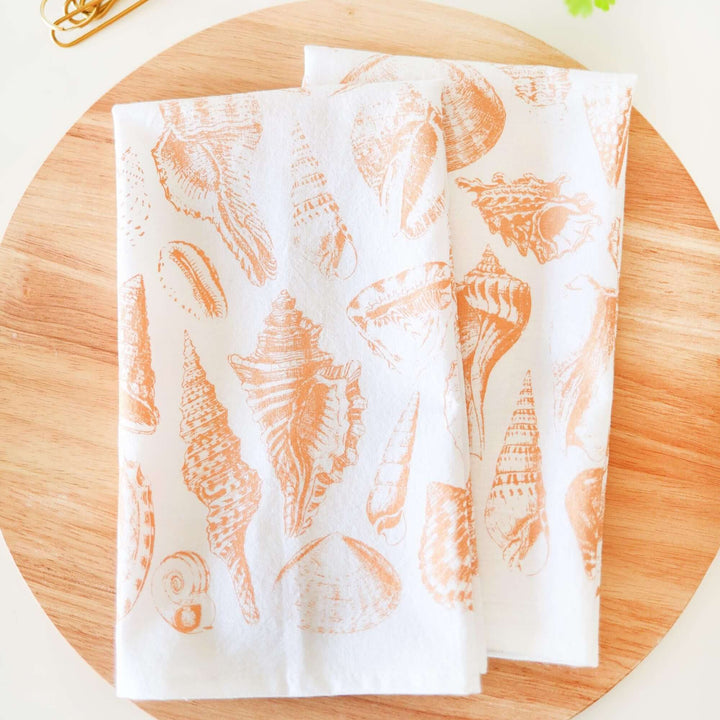 Vintage Coastal Seashell Tea Towel with watercolor-style seashells on fabric