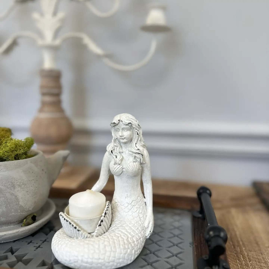 Vintage Coastal White Mermaid Candle Holder with seashell for tealight candle in a coastal-themed setting.