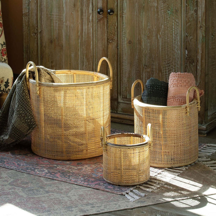 Vintage Coastal Woven Rattan Baskets with Handles (Set of 3) displayed with blankets for coastal home decor.