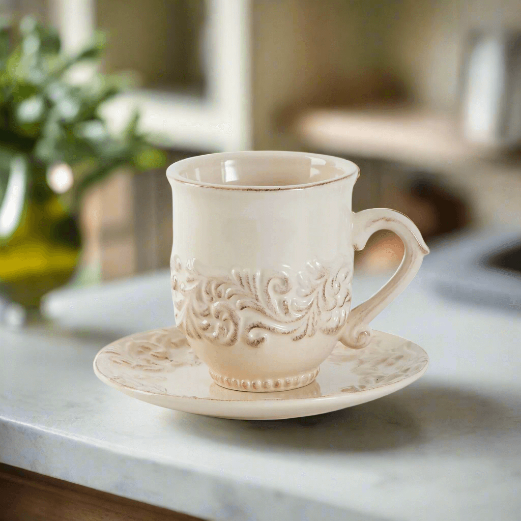 Vintage Cream Ceramic Cups and Saucers (Set of 4) with scrolling motif on marble counter