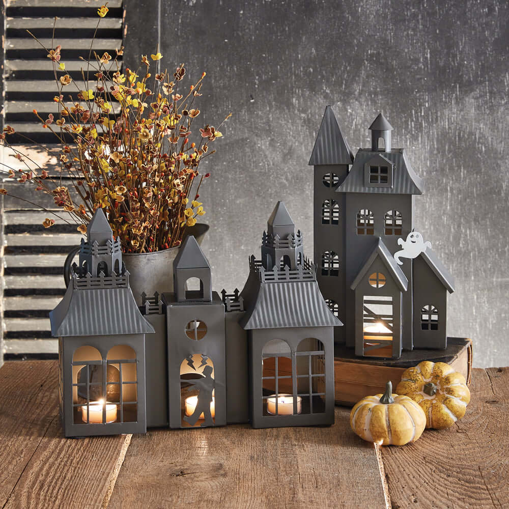 Vintage Frankenstein Castle Halloween metal tealight luminary with gothic design and pumpkins, creating a spooky ambiance.