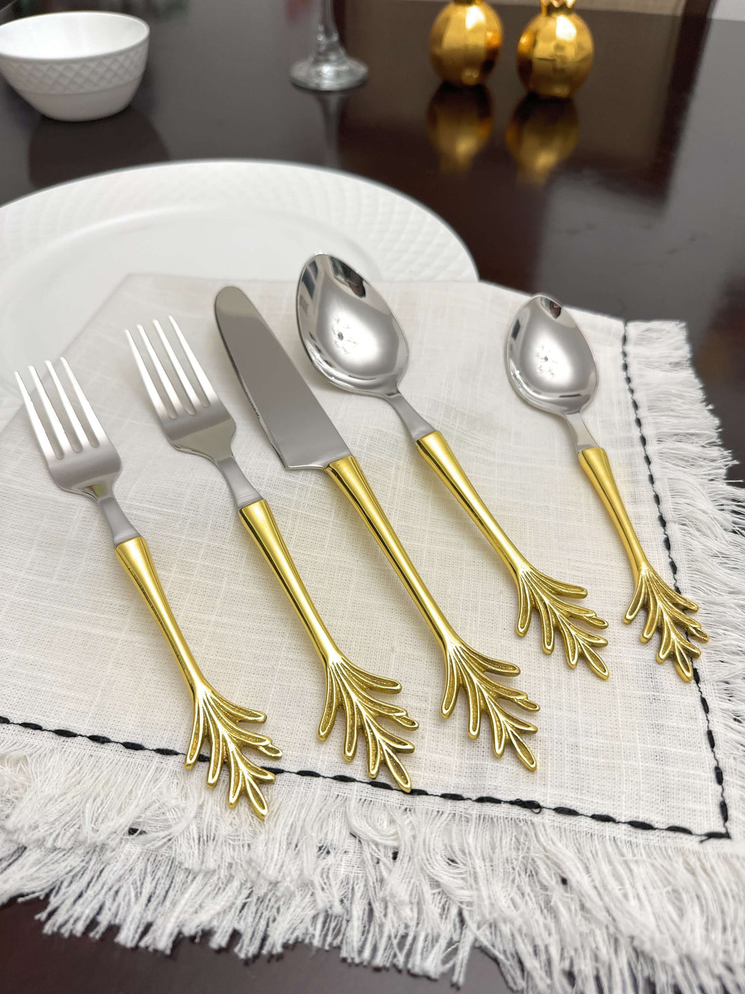 Vintage Gold Leaf Handle Flatware Set (20-Piece) displayed on elegant table setting with gold leaf design handles.