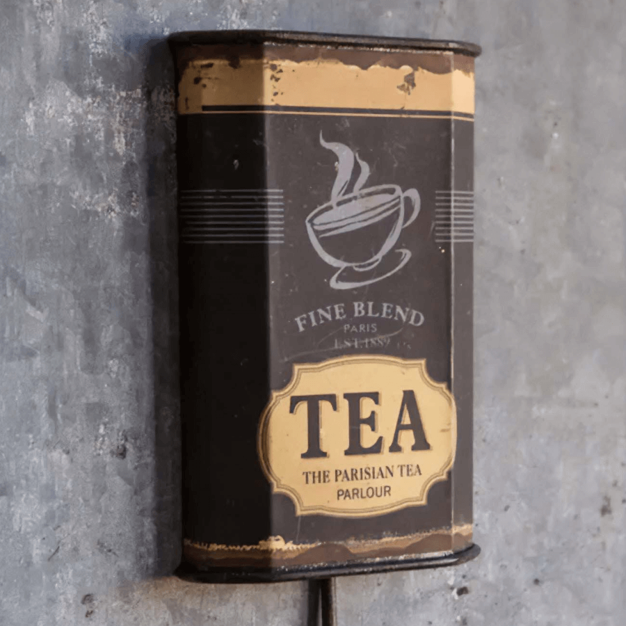 Vintage Parisian tea tin wall hook with distressed metal and nostalgic French café design.