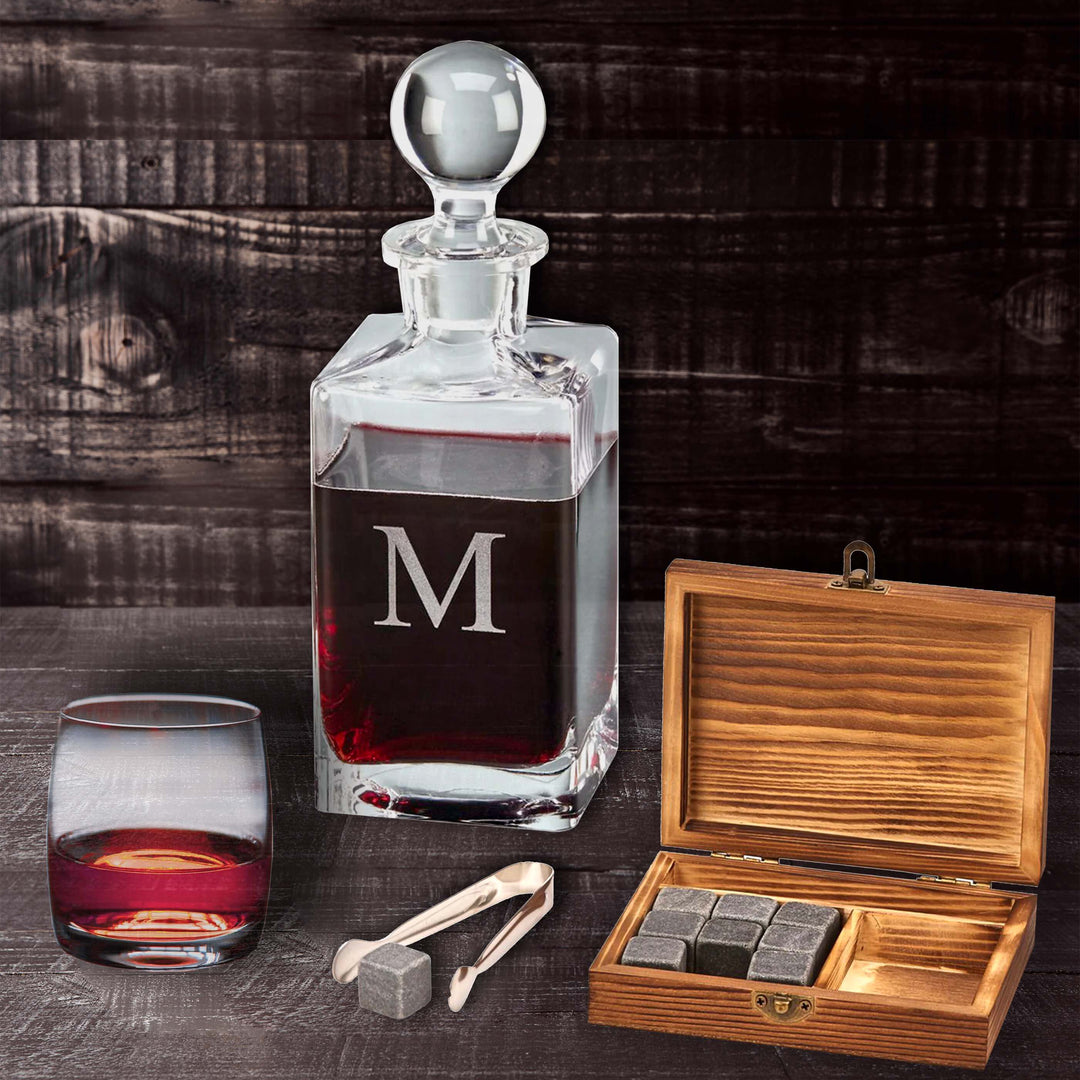 Vintage Whiskey Chilling Stone Set in Wooden Gift Box with decanter and glass on rustic background.