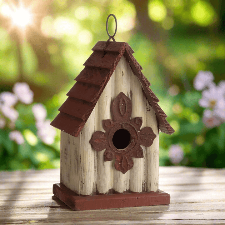 Vintage-Inspired Wooden Birdhouse with Terracotta Roof in garden setting, A-frame design evokes old countryside charm and timeless grace.