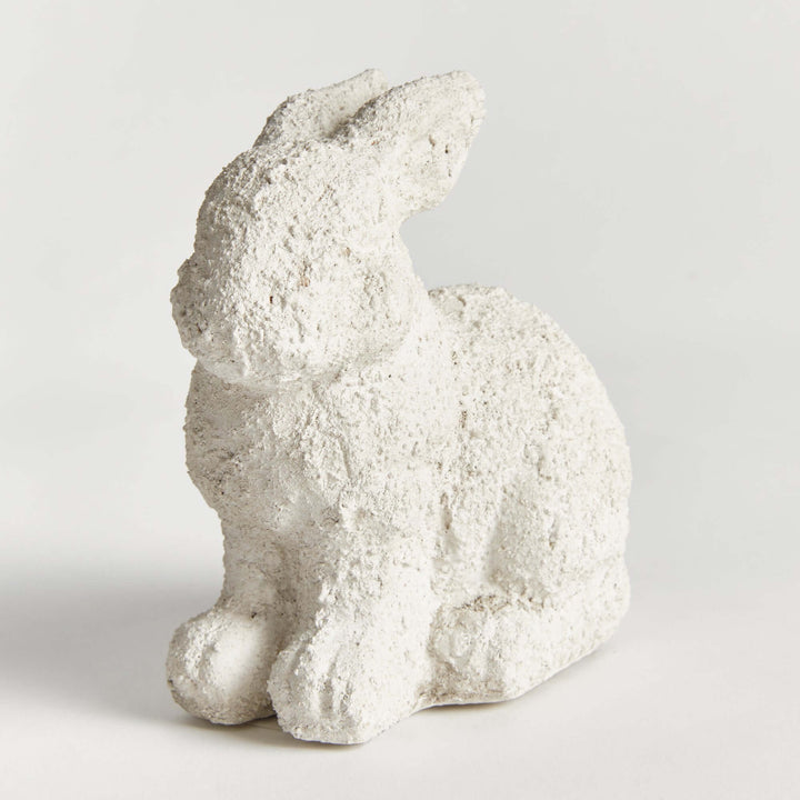 Weathered terracotta bunny garden statue, hand-sculpted with a textured finish, adding charm to outdoor spaces.