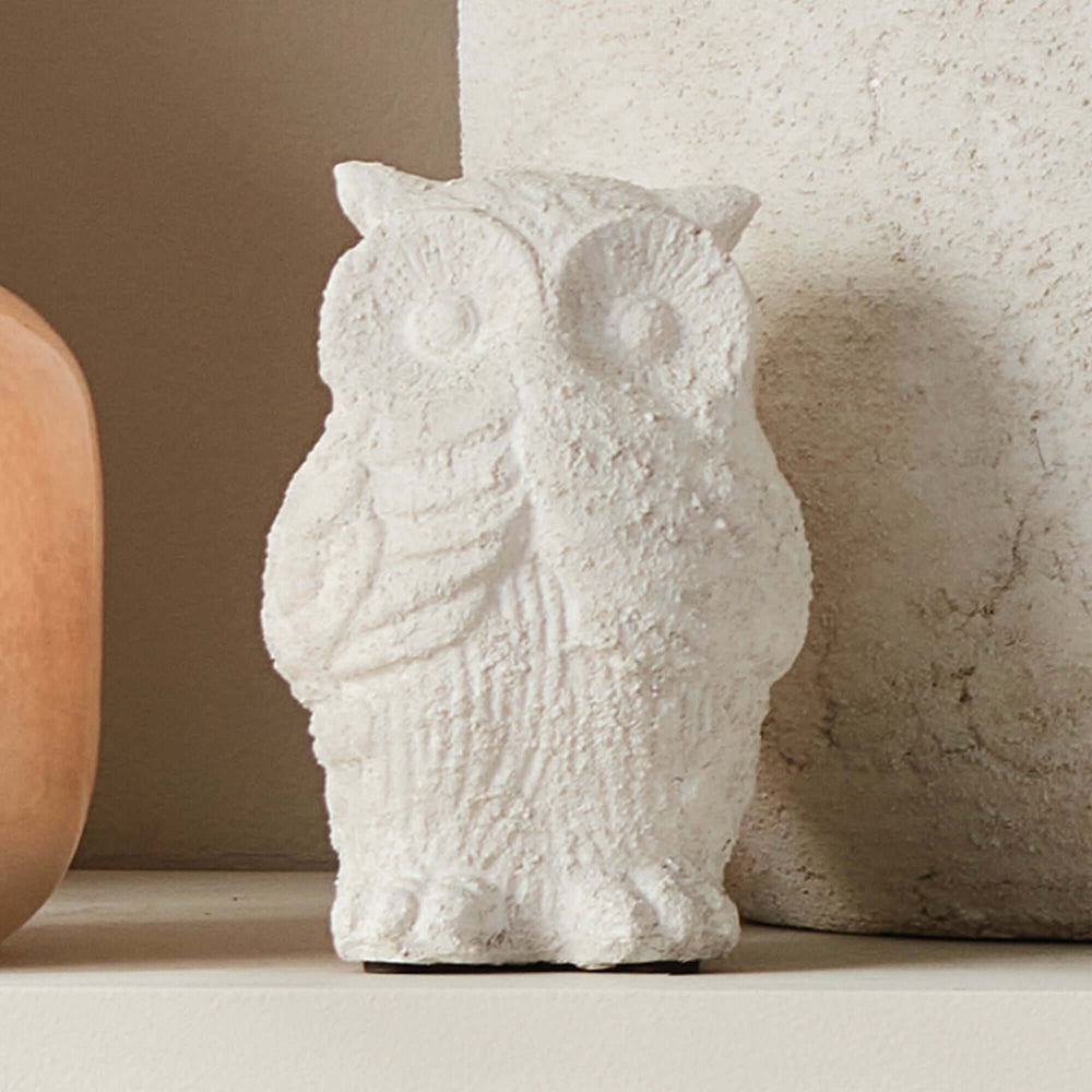 Weathered terracotta owl garden statue showcasing aged texture and a soft whitewash finish, perfect for outdoor decor.