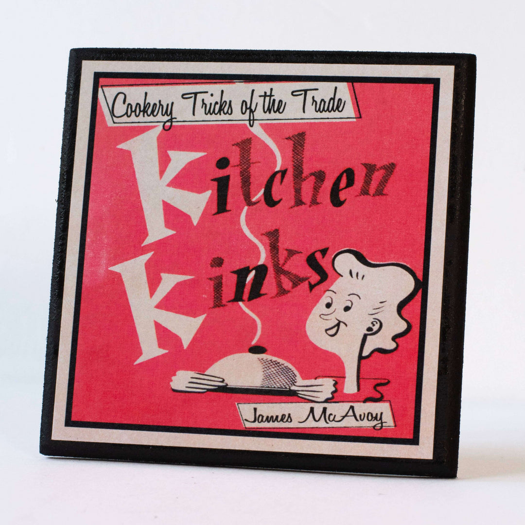 Book cover coaster of 'Kitchen Kinks' with a pink background and black text
