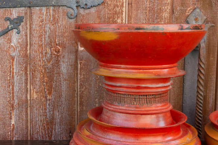 Antique Shan-Style Burmese Temple Vessel in traditional red lacquer against rustic wooden background.