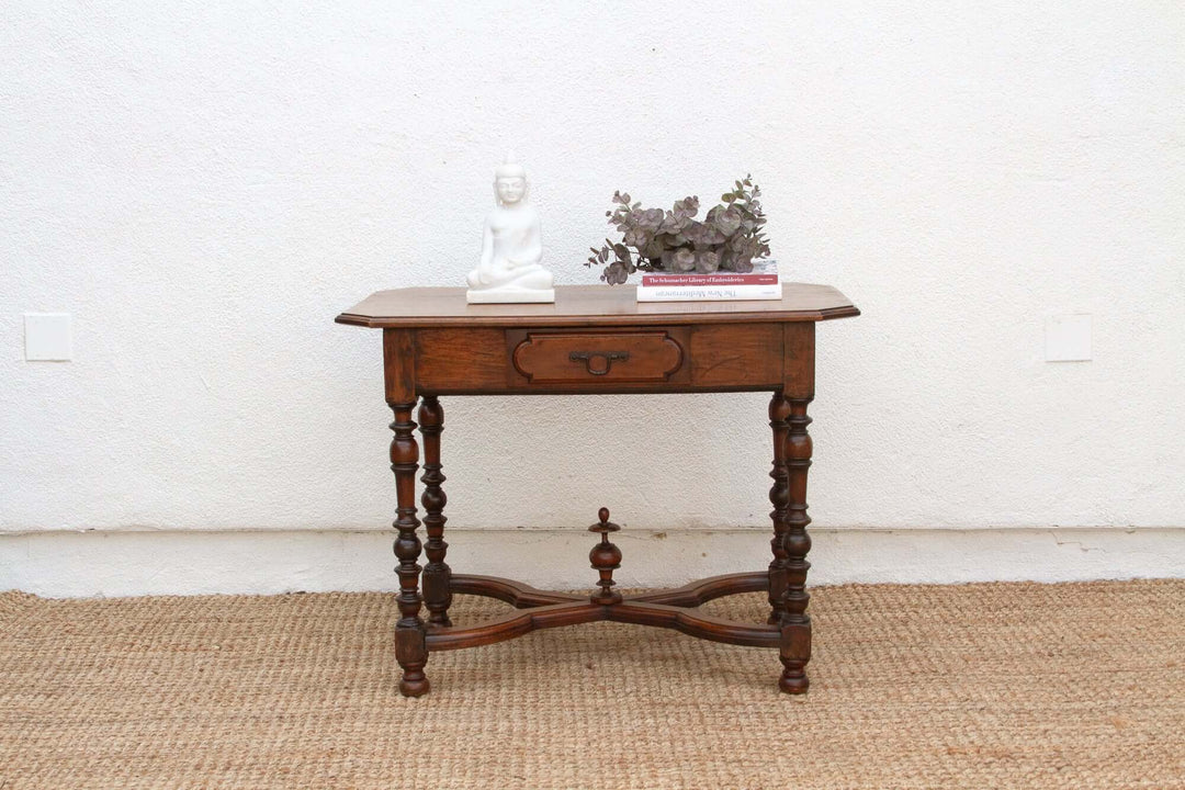 19th Century French Walnut Antique Writing Table on woven rug with floral decor and book