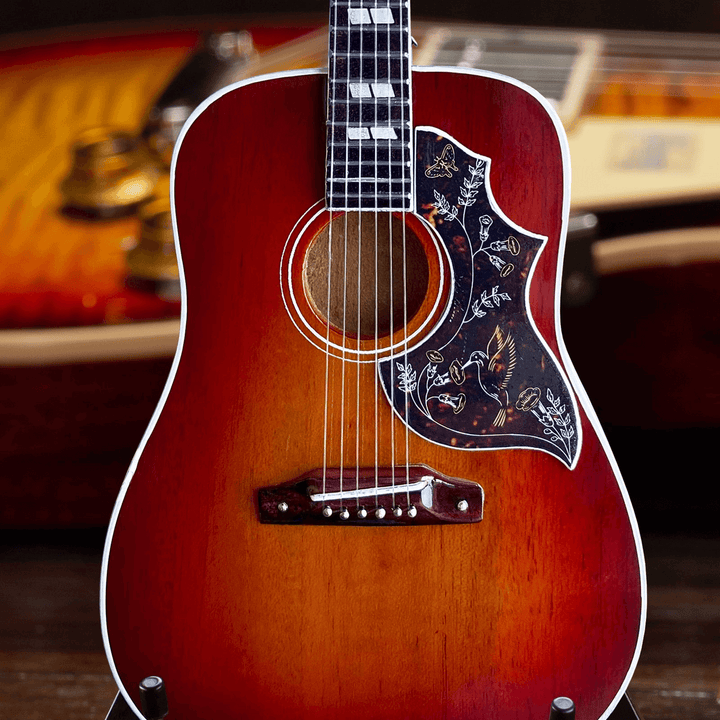 Gibson Hummingbird Vintage Cherry Mini Guitar Replica on display