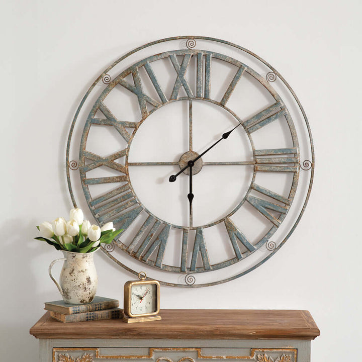 Large vintage farmhouse wall clock with Roman numerals and distressed metal frame, elegant rustic home decor piece.