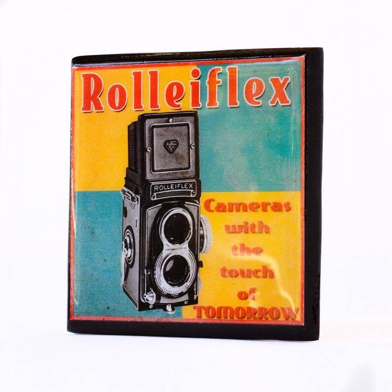 Vintage-style Rolleiflex camera coaster with colorful design on a white background