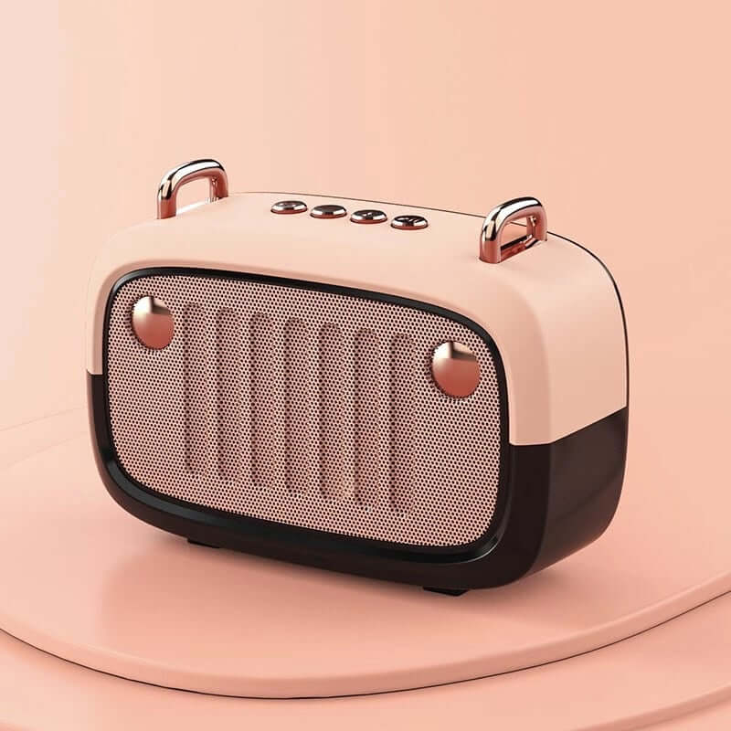 Pink and rose gold portable speaker on a pink background