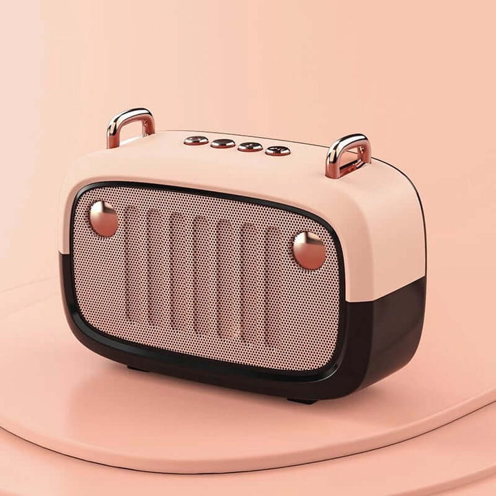 Pink and rose gold portable speaker on a pink background