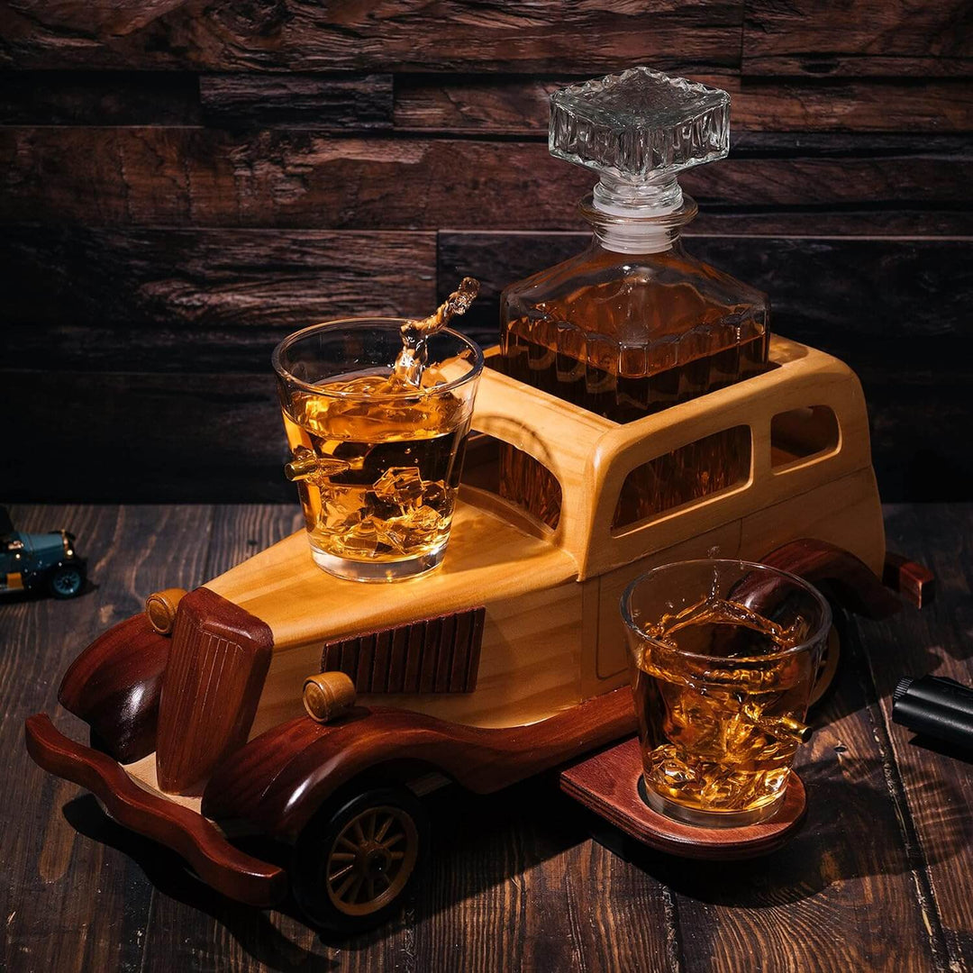 Wooden car-shaped decanter set with two glasses on a wooden surface