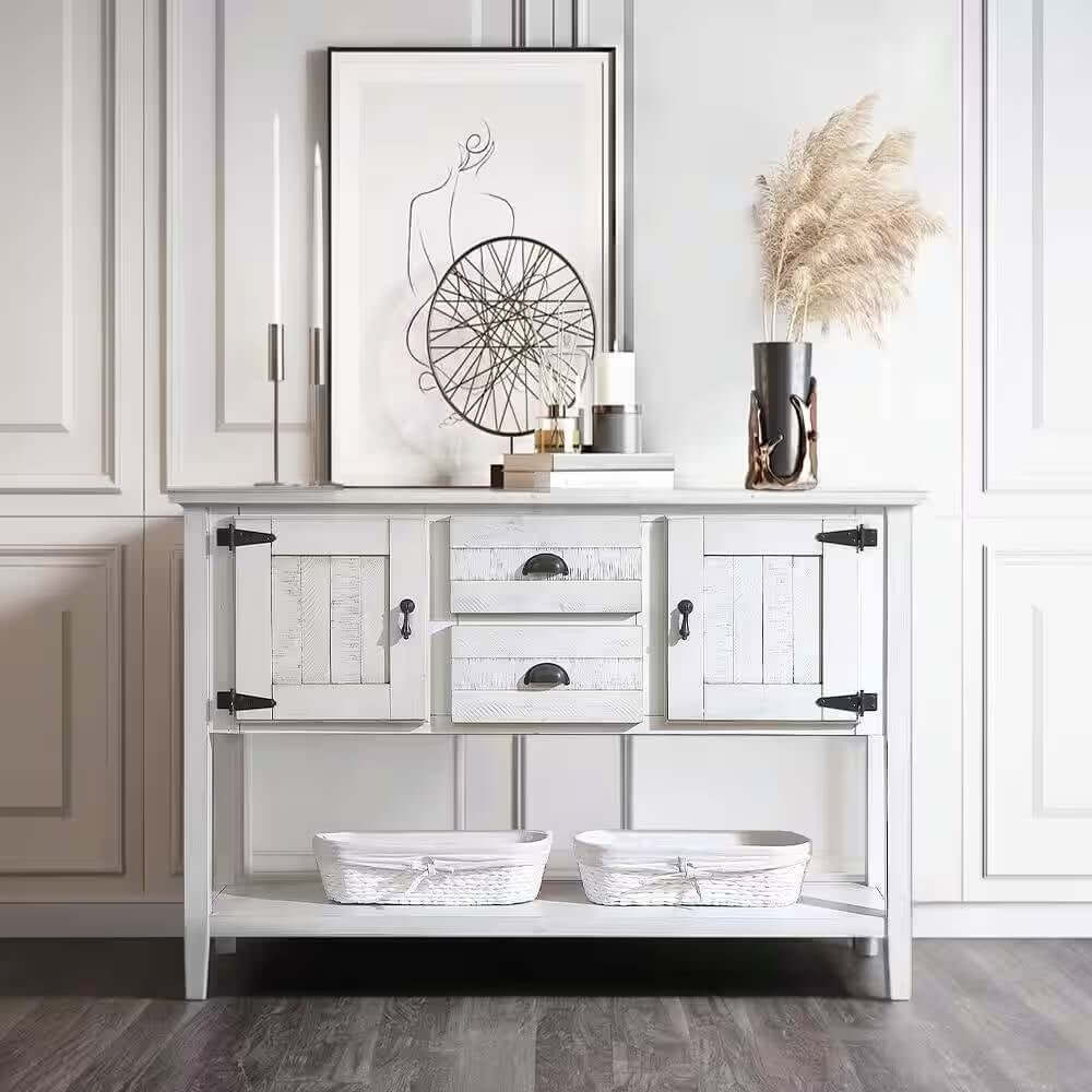 White wooden sideboard with decorative items in a room with white walls and wooden floor.