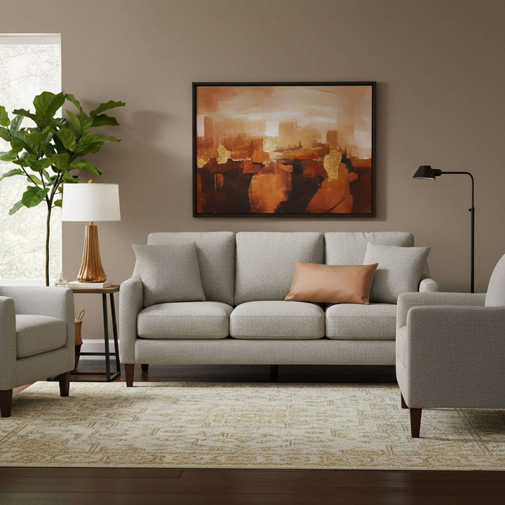 Living room with gray sofa, armchair, and abstract painting on wall