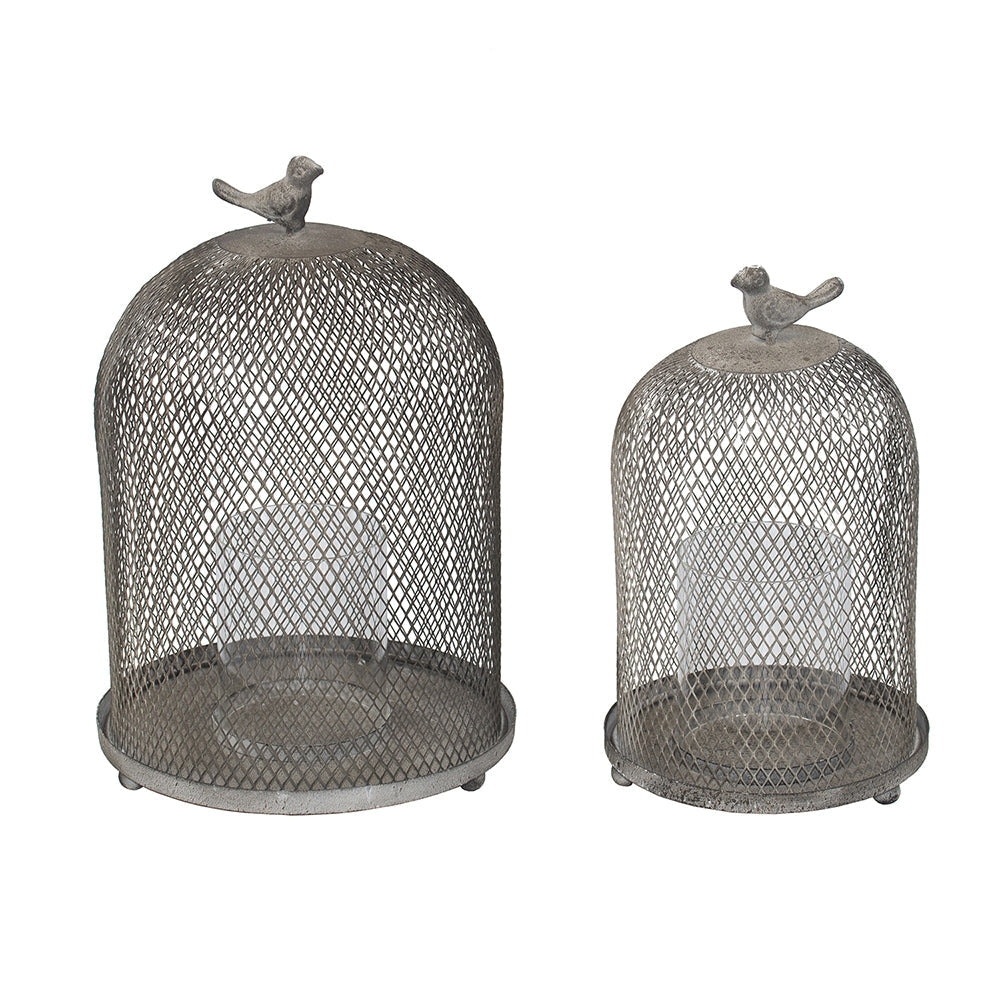 Two metal mesh domes with bird figurines on top on a white background