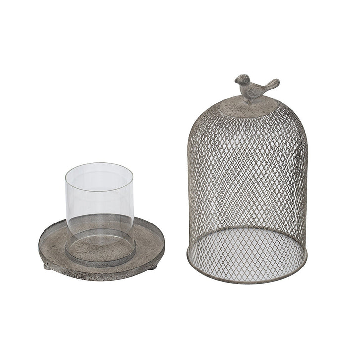 Decorative candle holder with a mesh-covered container, glass candle holder, and round metal base on a white background.