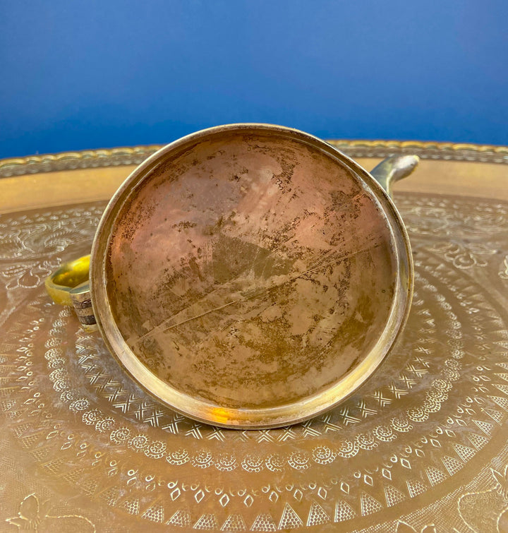 Interior view of Antique Brass TeaPot or Coffee Pot. Vintage Gifts. Showcasing the decorative handle and rustic finish.