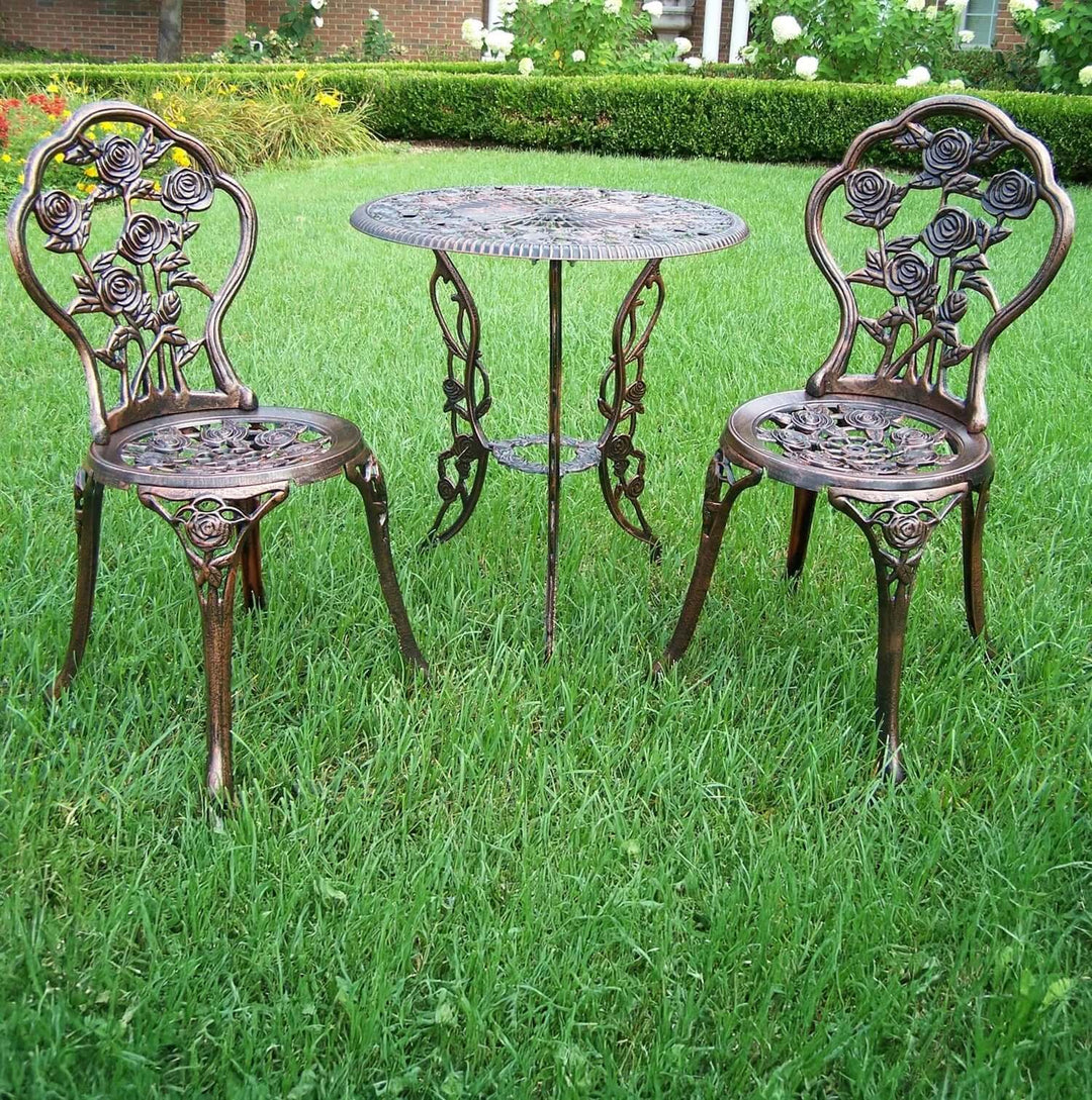 Antique Bronze Rose Outdoor Bistro Set (3-Piece) with intricate rose motif in a garden setting