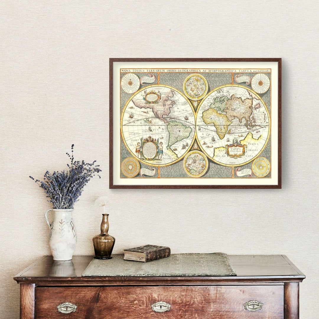 Framed world map on a wall above a wooden dresser with decorative items.