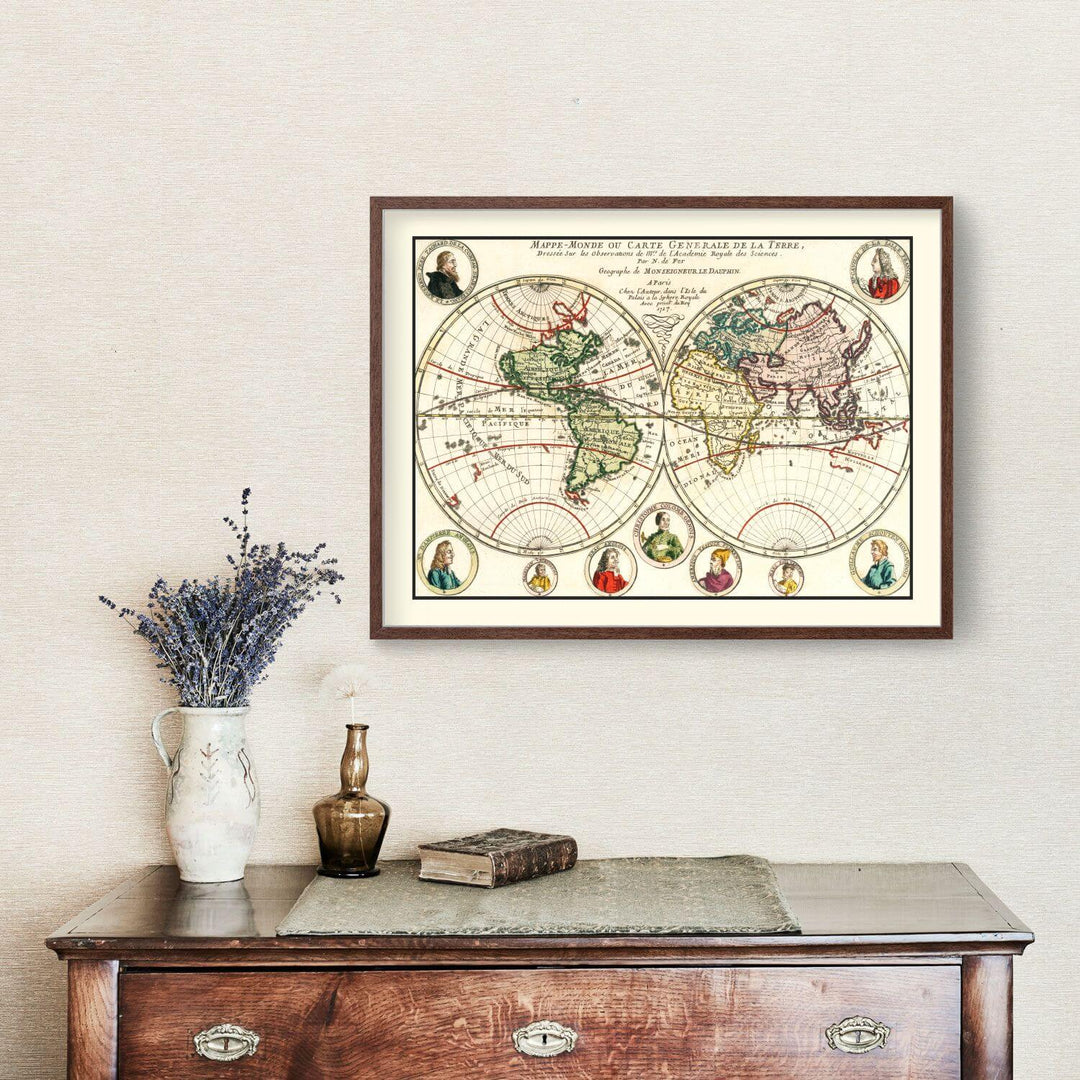 Framed world map on a wall above a wooden dresser with decorative items.