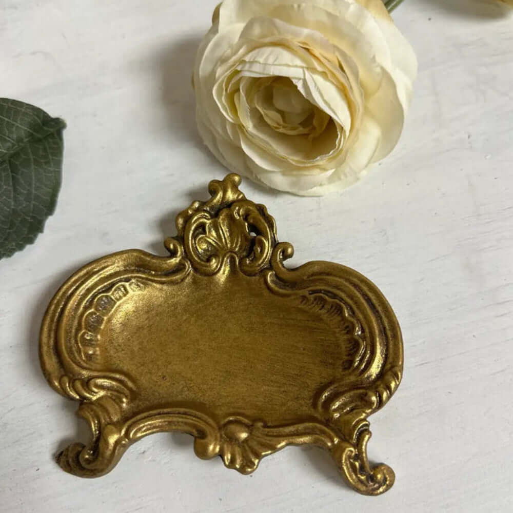 Antique Gold Baroque Jewelry Dish on a table with a rose