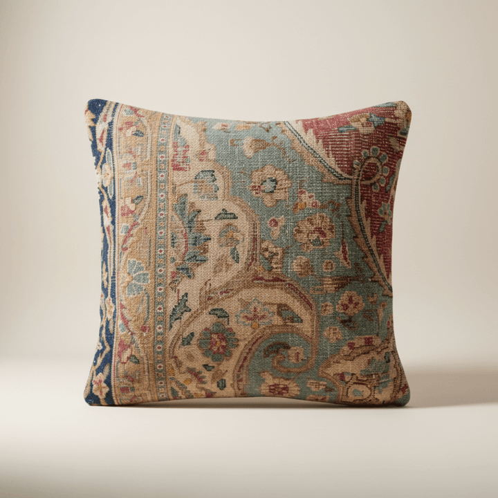 Decorative pillow with intricate paisley pattern on a beige background