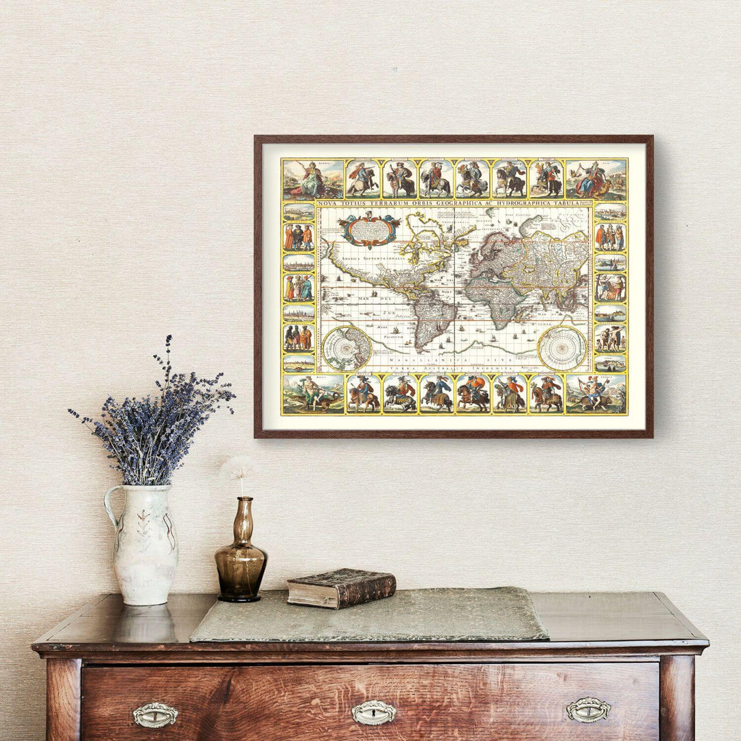 Framed world map artwork on a wall above a wooden dresser with decorative items.
