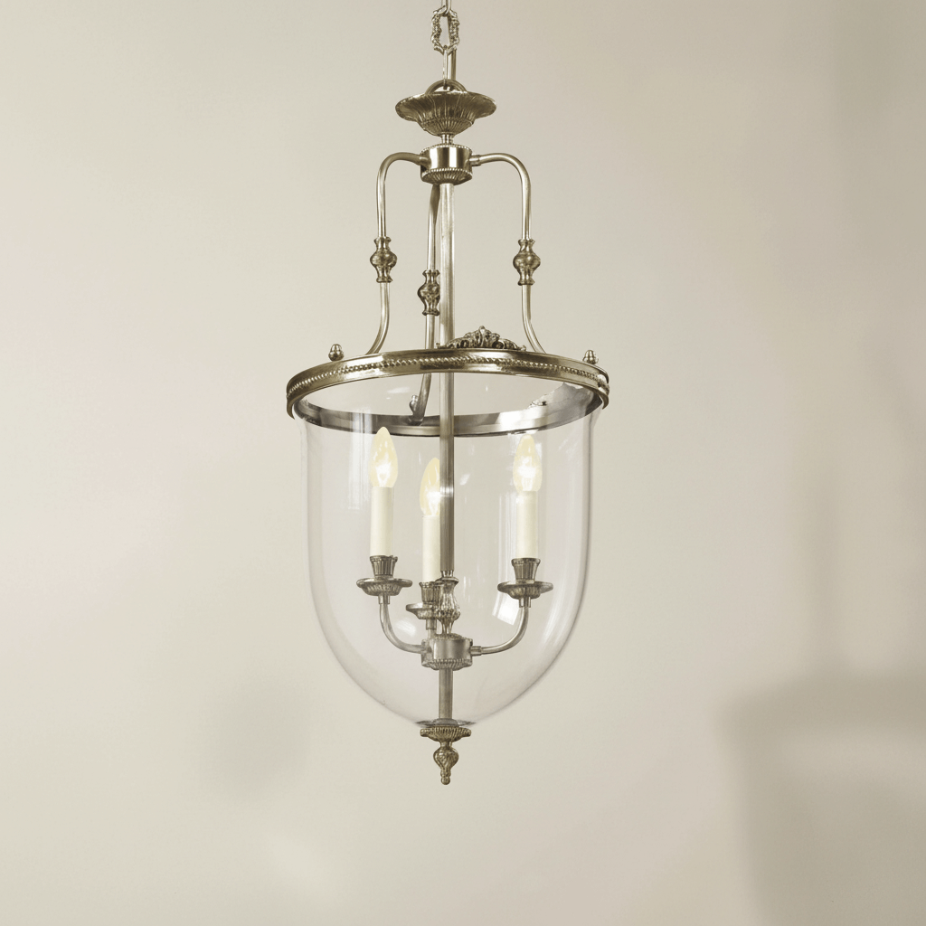 Vintage-style pendant light with clear glass shade on a beige background