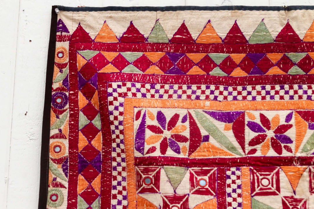 Close-up of colorful tapestry with geometric patterns on a white background