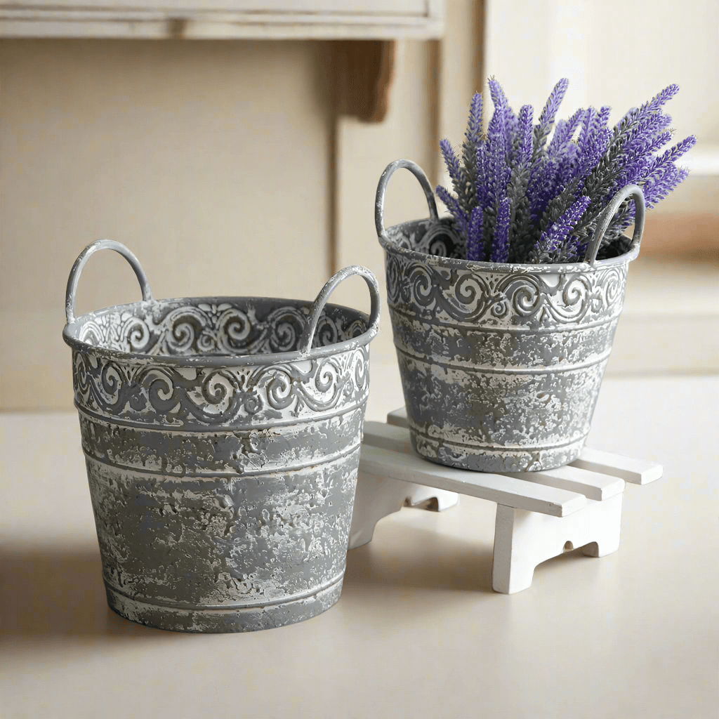 Set of 2 antique metal buckets with handles, distressed finish, perfect for rustic decor or flower planters.