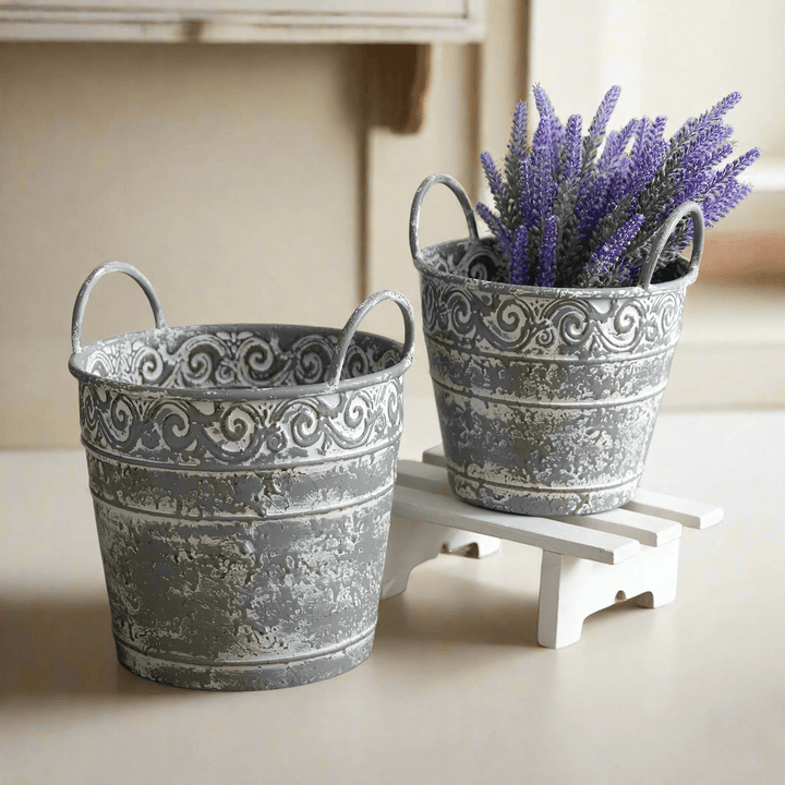 Set of 2 antique metal buckets with handles, distressed finish, perfect for rustic decor or flower planters.